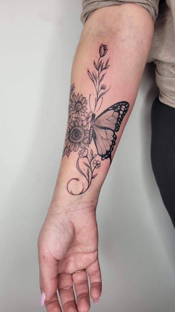butterfly and sunflower tattoo on women's forearm