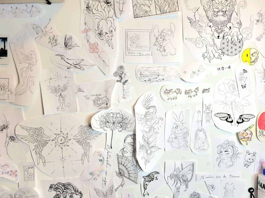 flash tattoo ideas of variety of designs on a wall of a private tattoo studio located in Toronto