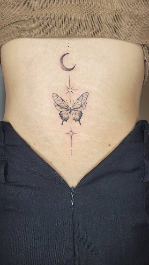 custom butterfly tattoo on the back of a women