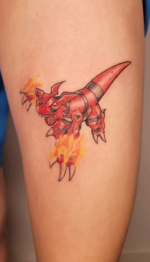 anime tattoo of a Digimon on a leg of a male