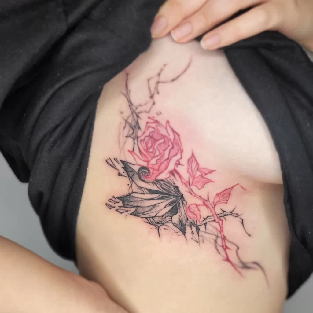butterfly and flower tattoo on the side abdomen of a female
