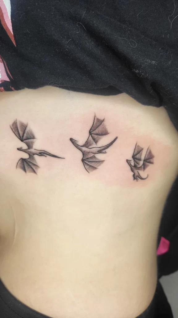 dragon tattoos on a women's stomach done by Angeloop Ink a calgary best tattoo artist