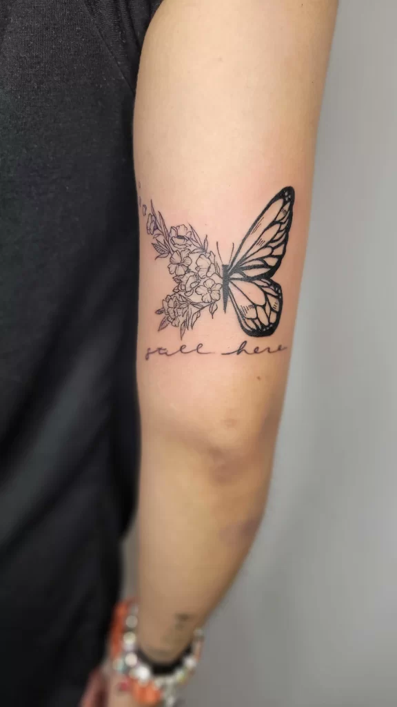 fine line butterfly birth flower tattoo with detailed floral design