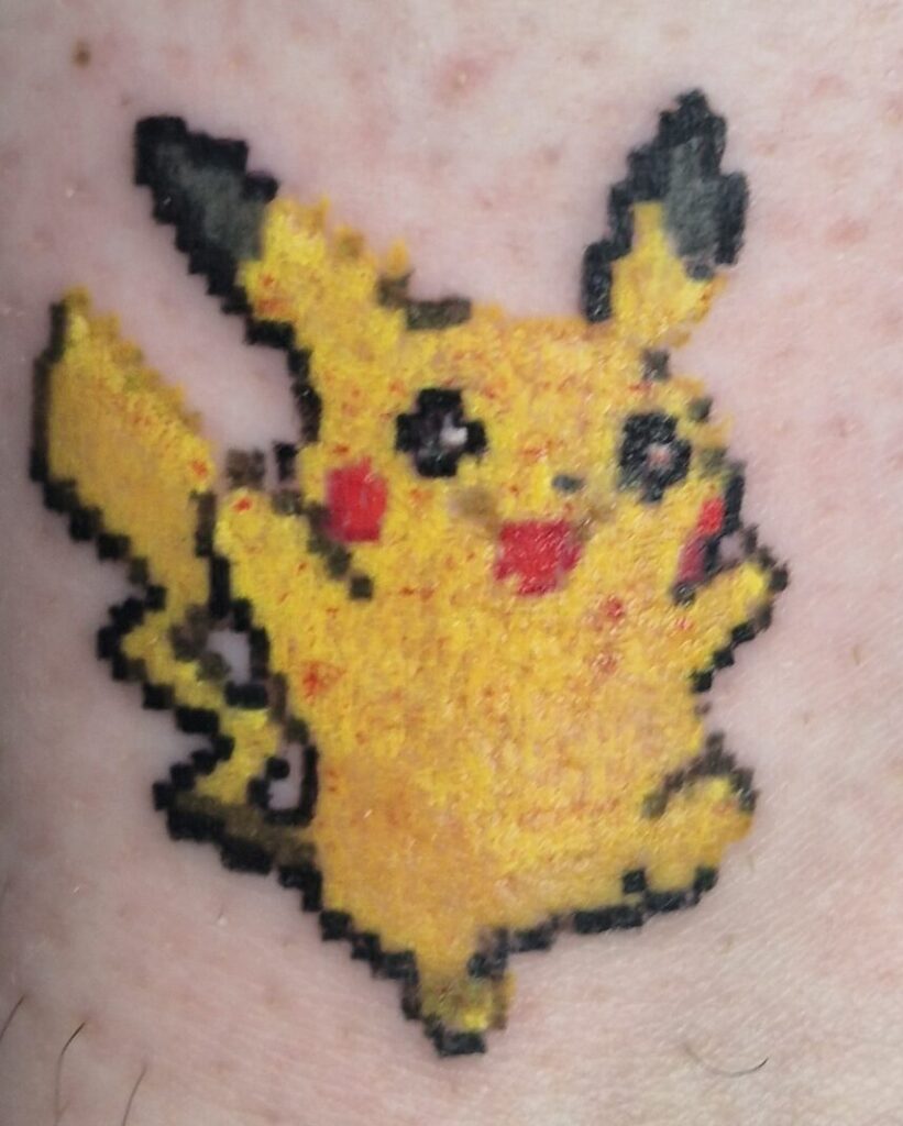 Pixilated tattoos Calgary featuring retro Pikachu tattoo with bright yellow colour and bold black outline