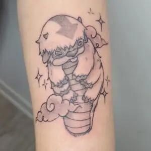 Fine line Appa tattoo inspired by Avatar: The Last Airbender featuring cloud elements and kawaii anime styling created by Angeloop Ink Tattoo Studio in Calgary.